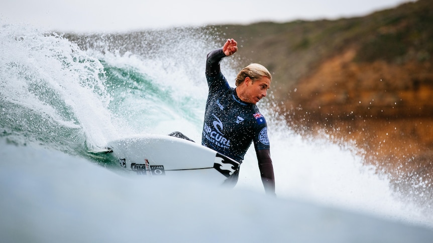 Ethan Ewing surfs a wave