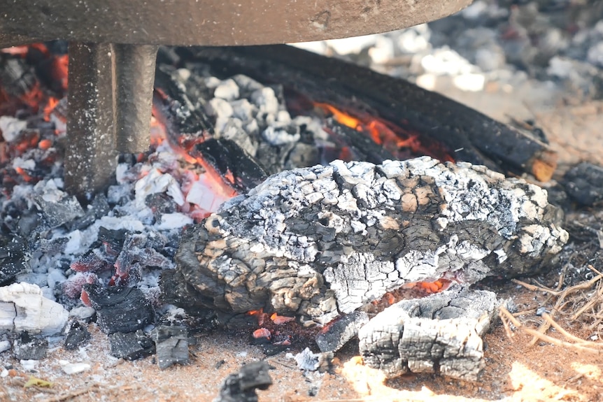 Coals underneath a camp oven