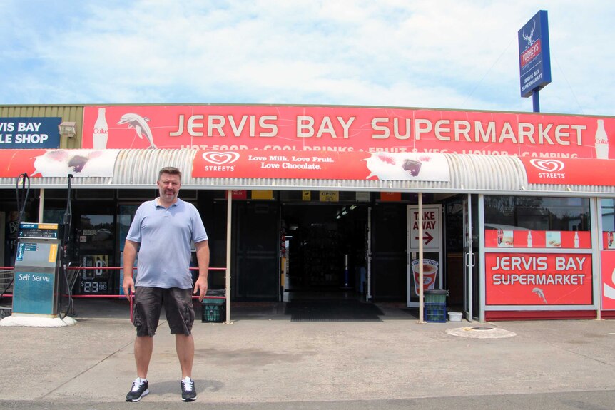 Damian Erwich outside the supermarket he owns in Jervis Bay.