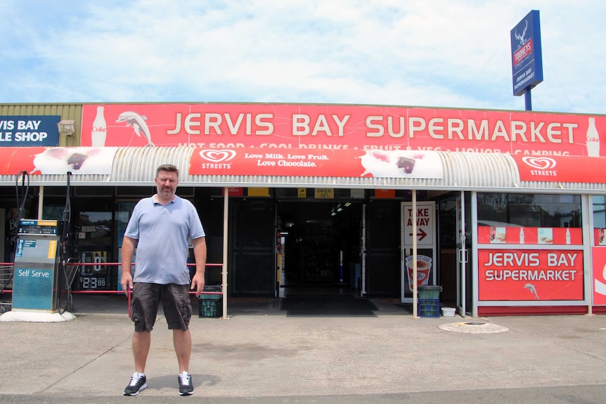 Damian Erwich outside the supermarket he owns in Jervis Bay.