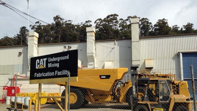 Machinery sits inside the fence at the Wivenhoe depot of Caterpillar in north-west Tasmania.