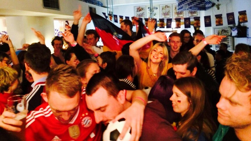 German fans at the Hofbrauhaus in Melbourne celebrate their team's 1-0 victory in the World Cup final.