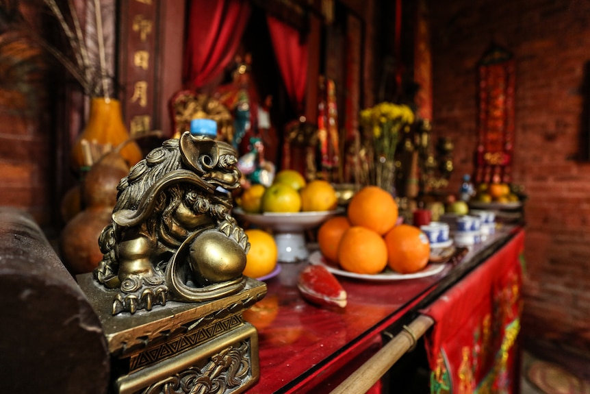 A close up of the gifts of food and incense on the main altar.