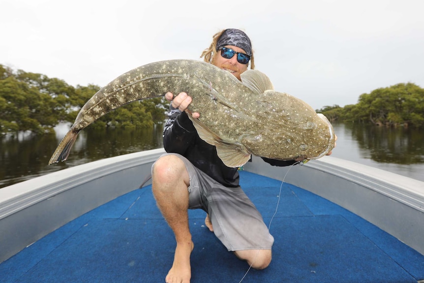 Paul Lennon holding a 95cm dusky flathead.