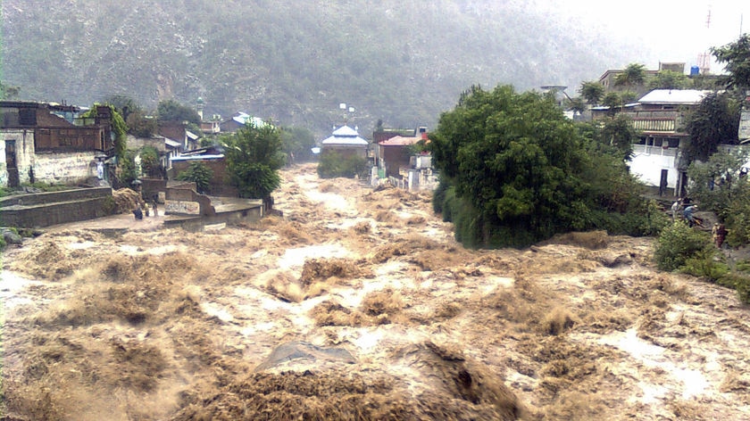 Severe floodwaters rush through a village in Pakistan