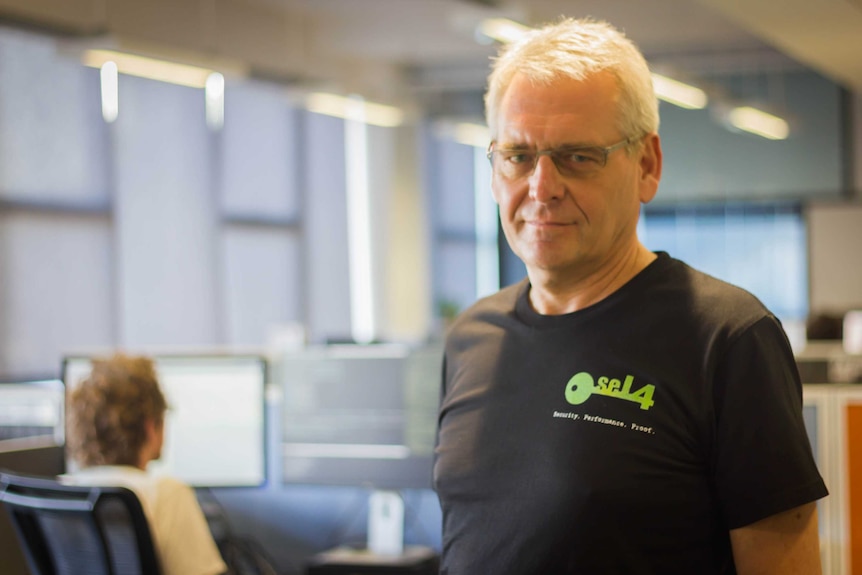 Professor Heiser stands in a computer lab.