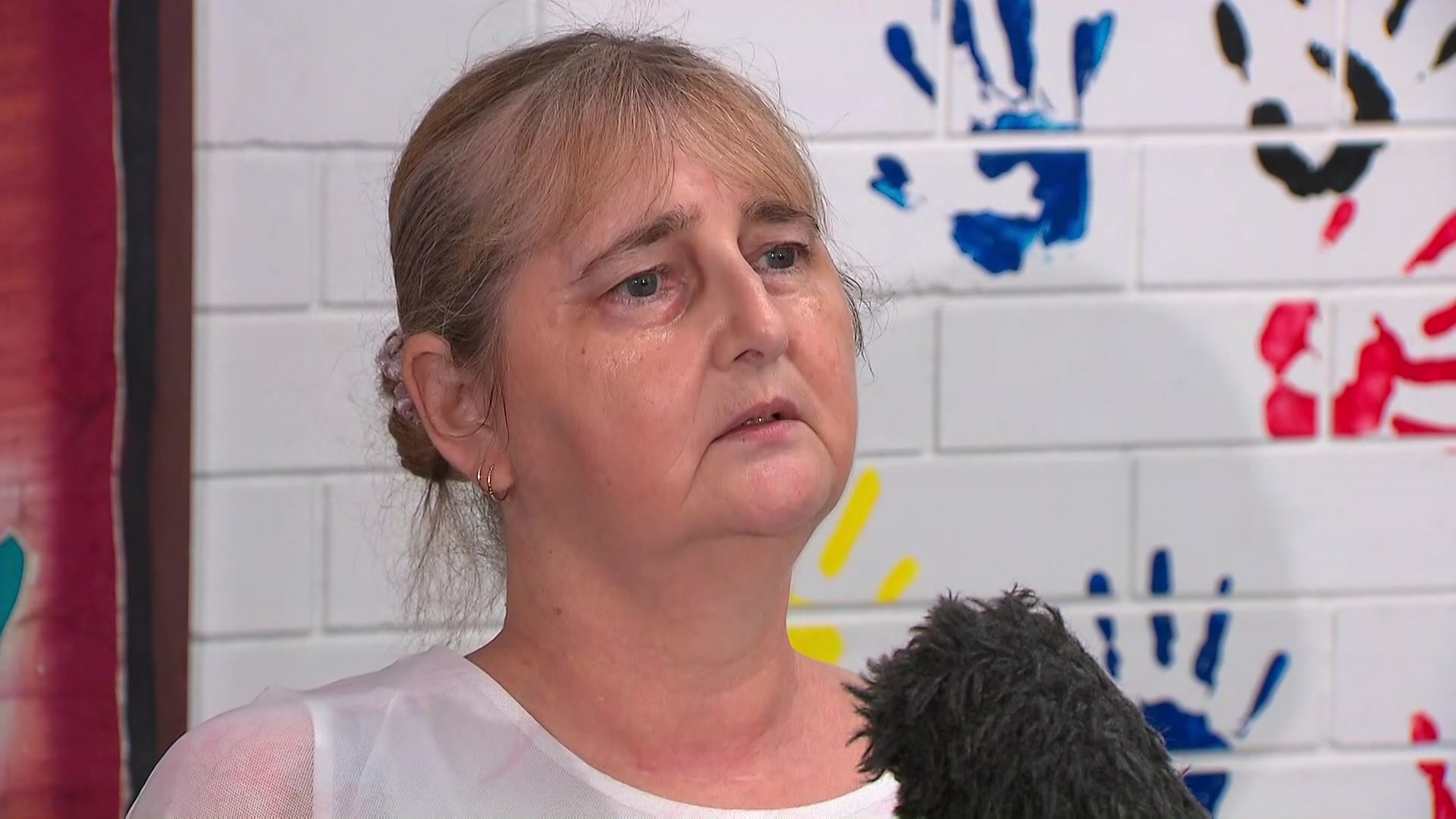 a woman speaking into a media microphone