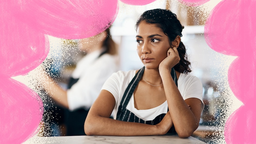 Disgruntled and thoughtful-looking woman chef in the kitchen surrounded by bright pink colour treatment