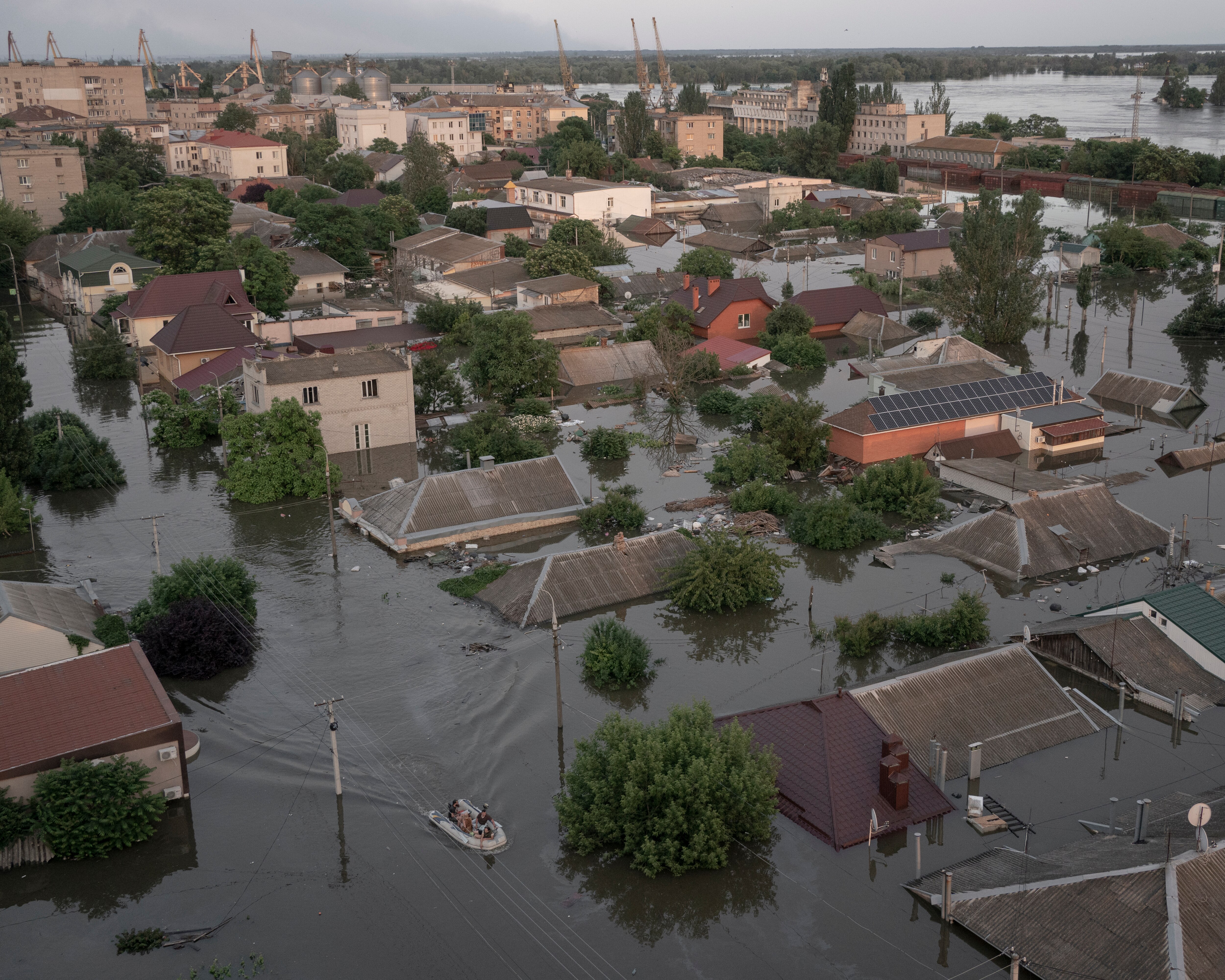 An aerial view of a town submerged in water, some roofs under the water