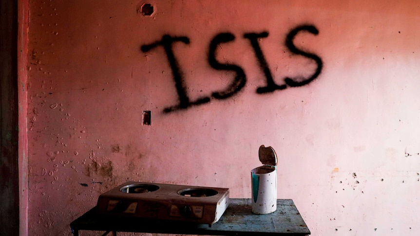 A pink wall with 'ISIS' scrawled across it in black graffiti