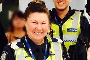 Rosa Rossi in police uniform and smiling.