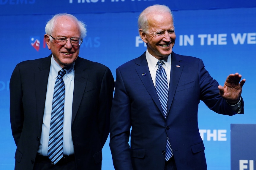 Joe Biden and Bernie Sanders standing next to each other.