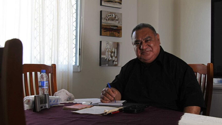 A photo of Aisea Moala sitting at his dinner table.