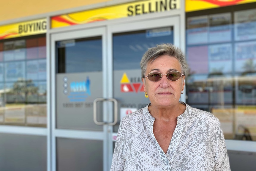 Woman stands in front of shop