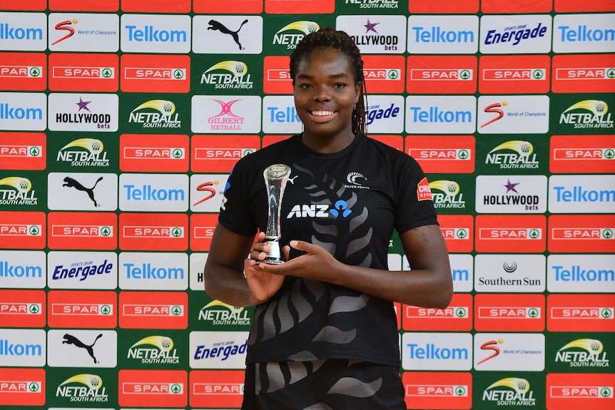 Nweke smiles and stands tall as she poses with her trophy.