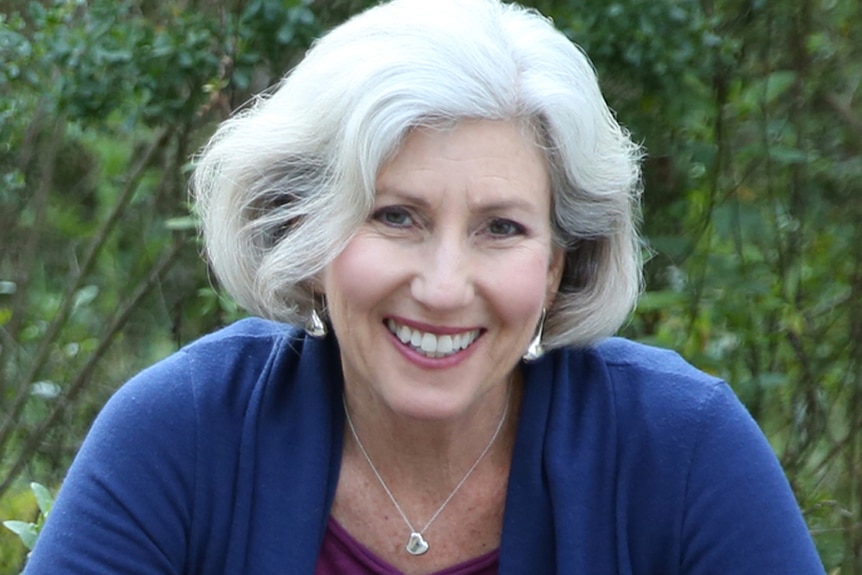 A close-up photo of Ann Davidman in a garden setting