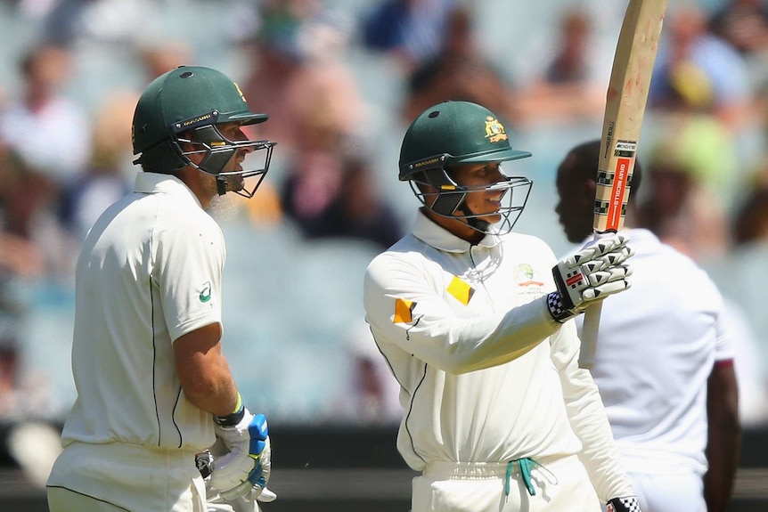 Usman Khawaja celebrates a half-century