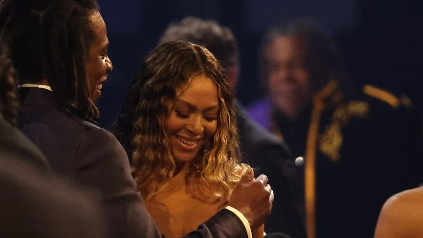 Beyoncé smiling next to her husband Jay-Z 