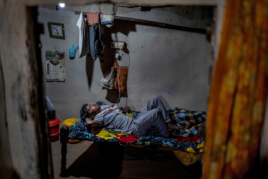 a man suffering sickle cell disease rests in his bed inside his home 