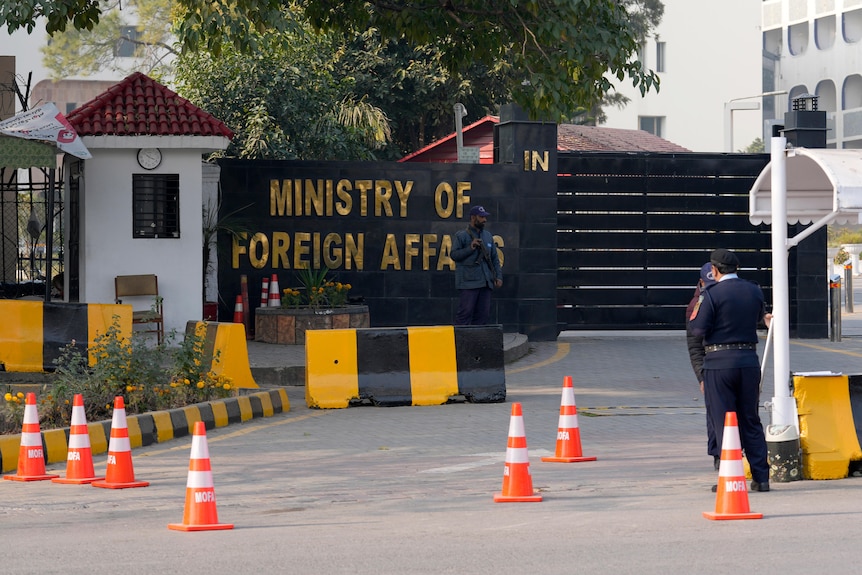 Police officers stand guard at the main entry gate of Pakistan's Ministry of Foreign Affairs.
