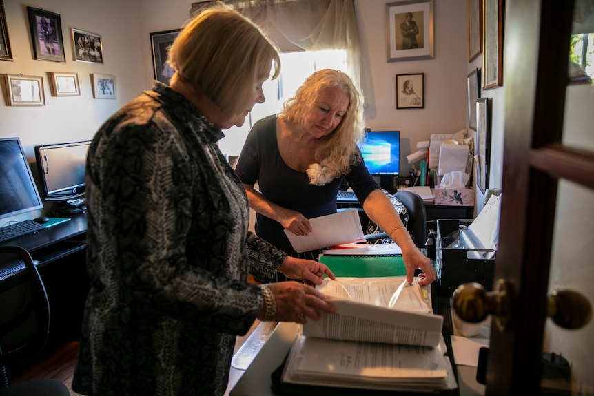 two women go through files in a home office