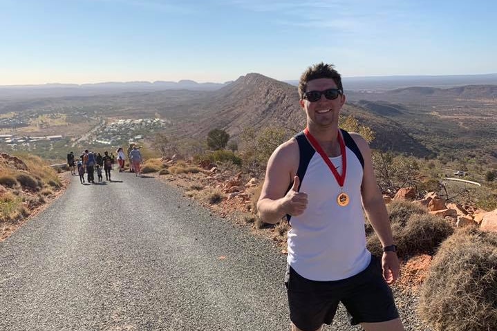 Josh Burgoyne giving the thumbs up, after climbing a large hill.