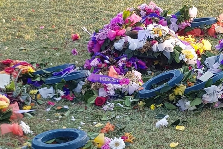 Trashed wreaths and flowers on the ground at Box Hill Memorial Gardens.