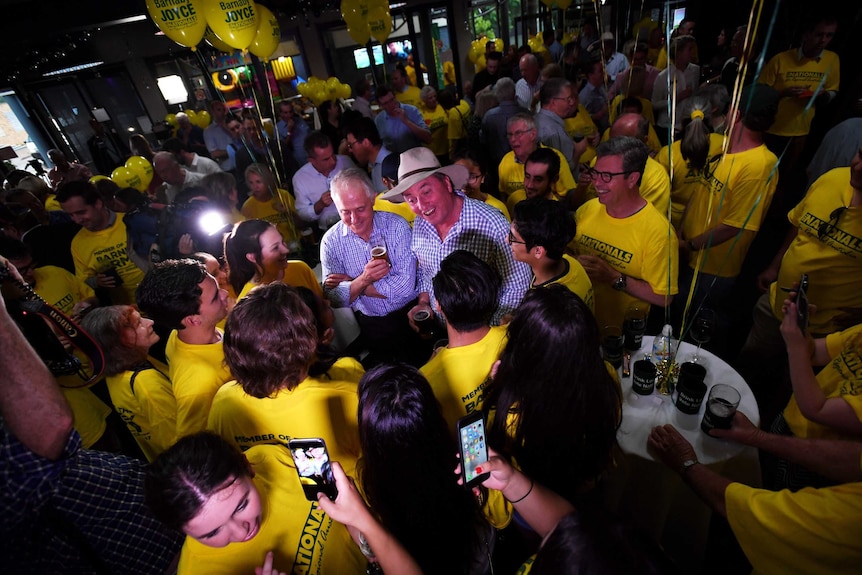 Barnaby Joyce and Prime Minister Malcolm Turnbull are surrounded by supporters.