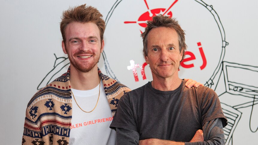 Photograph of Finneas O'Connell and Richard Kingsmill standing together in the triple j offices.
