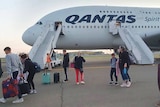 Passengers disembarking from a Qantas plane