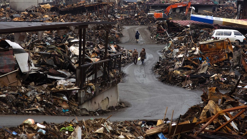 Long range view of piles of debris following 9.0 magnitude tsunami in Japan.