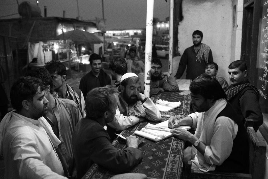 Passengers buy tickets from the Ahmad Shah Abdali Baba bus company in Kabul's western outskirts.