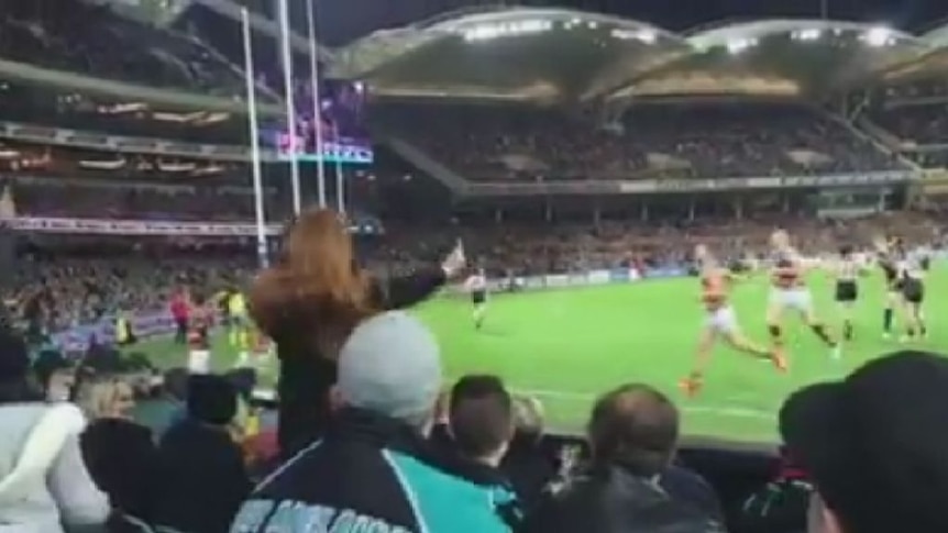 A fan appears to throw a banana at AFL star Eddie Betts.