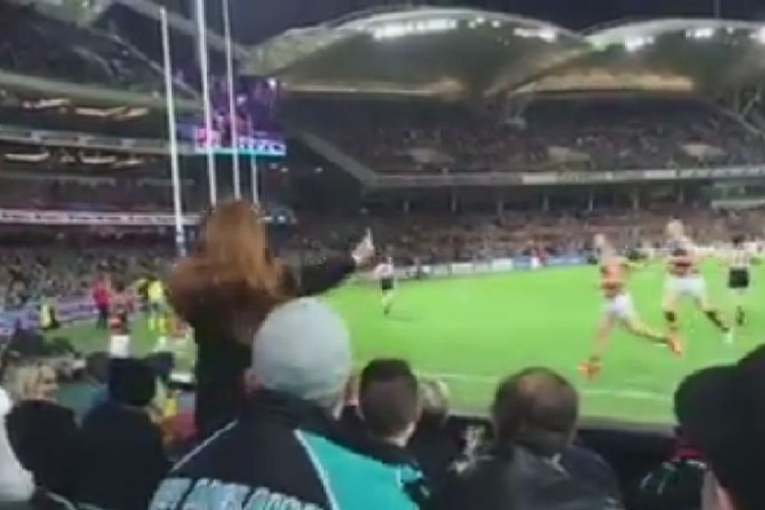 A fan appears to throw a banana at AFL star Eddie Betts.