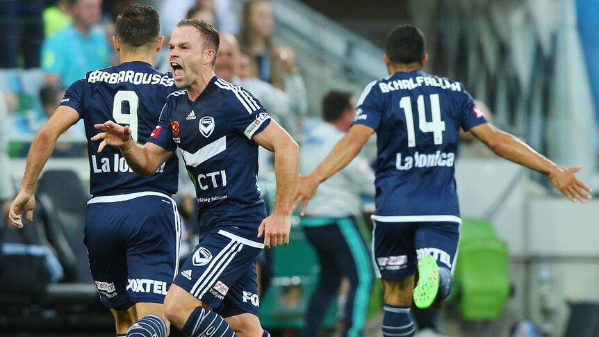 The Victory's Leigh Broxham celebrates a goal by Fahid Ben Khalfallah against Melbourne City.