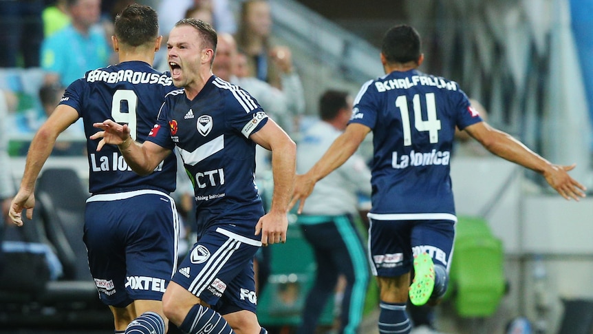 The Victory's Leigh Broxham celebrates a goal by Fahid Ben Khalfallah against Melbourne City.