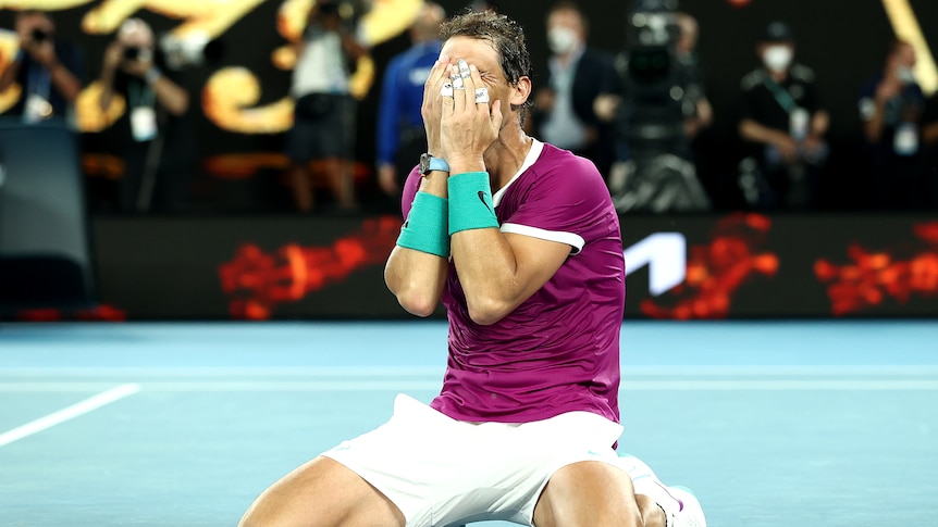 Rafael Nadal puts his hands to his face while on his knees after winning the Australian Open.