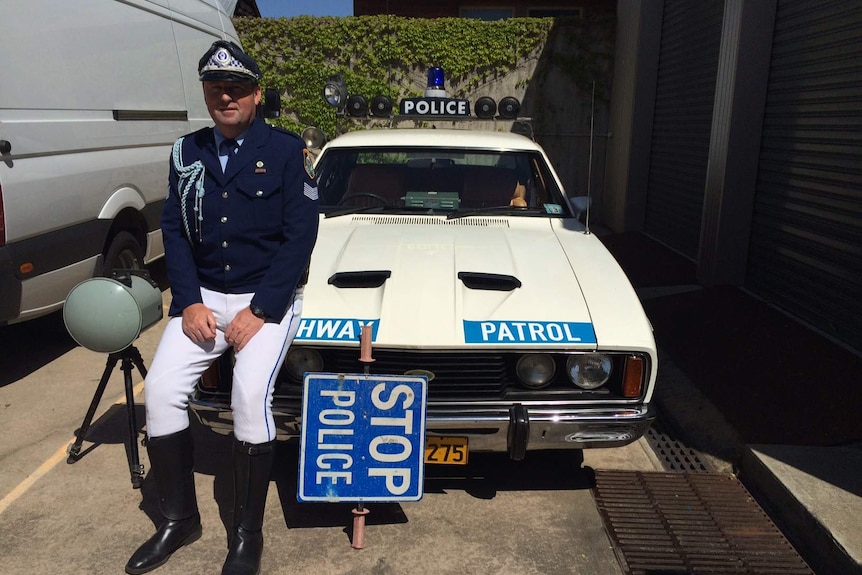 Head of the New South Wales Historic Patrol Vehicles Association Tony Fitzgerald with a 1970s highway patrol Ford Falcon.