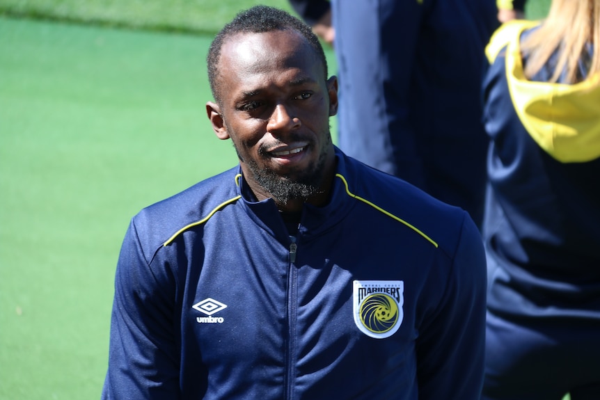 Usain Bolt smiles at his first training session with Central Coast Mariners in Gosford.