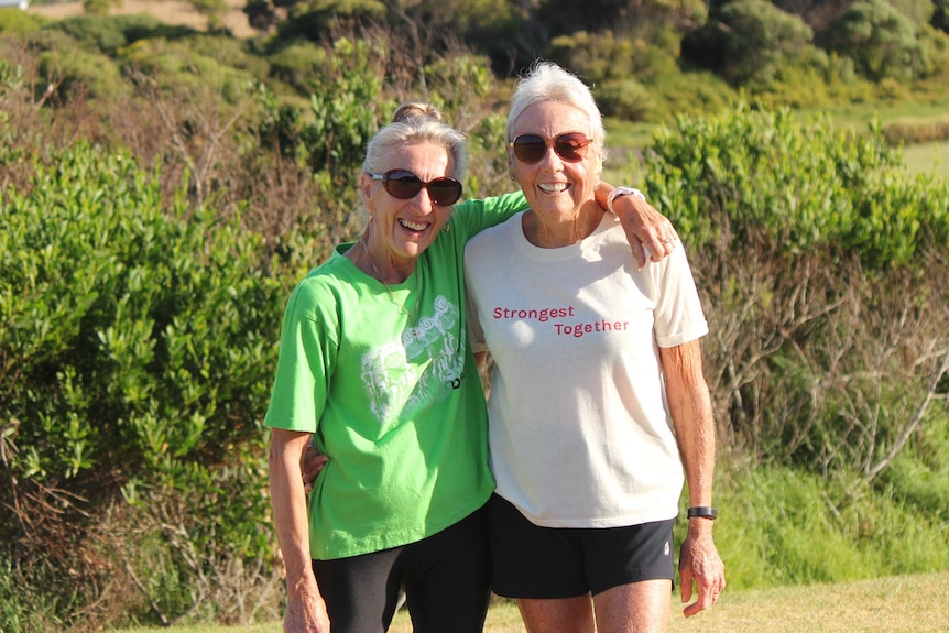 Olga Lemke has her arm around Judy Amoore Pollock.