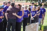 Bruce Morrissey embraces community members in front of Jayde Kendall memorial