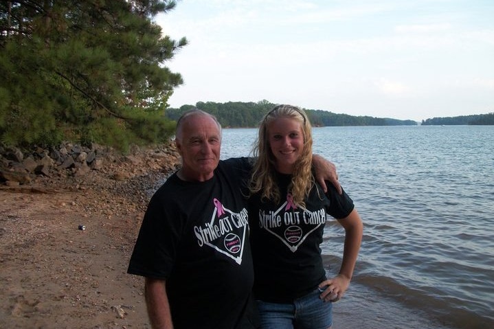 Douglas Parkhurst poses with his granddaughter by a lake.