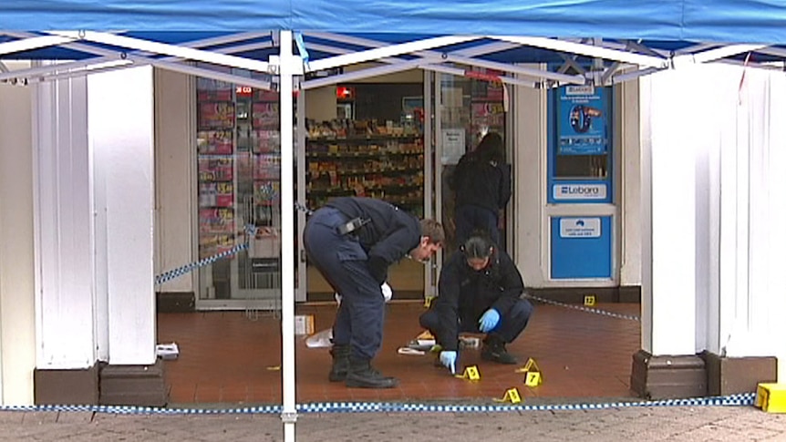 Forensic police inspect the crime scene where Timothy McCarthy, 41, was hit and left unconscious in Civic.