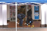 Forensic police inspect the crime scene where Timothy McCarthy, 41, was hit and left unconscious in Civic.