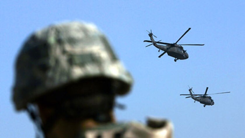 A US soldier watches two Blackhawk helicopter leaving forward operating base Loyalty in Baghdad.