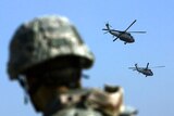 A US soldier watches two Blackhawk helicopter leaving forward operating base Loyalty in Baghdad.