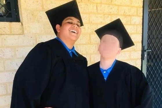 Cassius and a school friend pictured in graduation attire