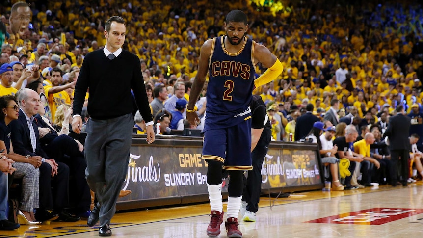Injured Kyrie Irving of the Cleveland Cavaliers leaves game one of NBA Finals against Golden State.