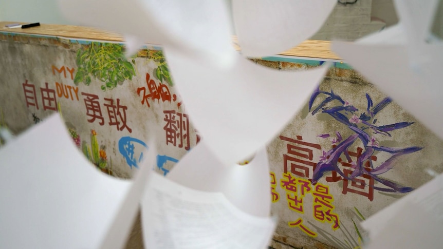 White paper in front of a graffiti wall. 