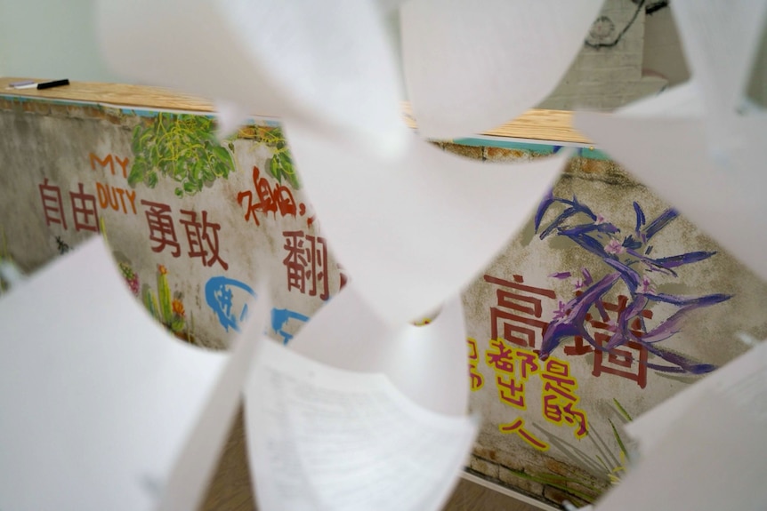 White paper in front of a graffiti wall. 